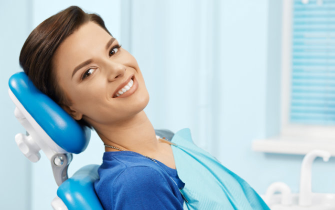 Woman with beautiful smile in a dental chair
