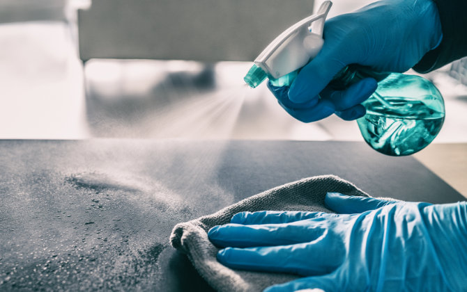 a person sterilizing surfaces between appointments at Riverwood Dental, Atlanta, GA