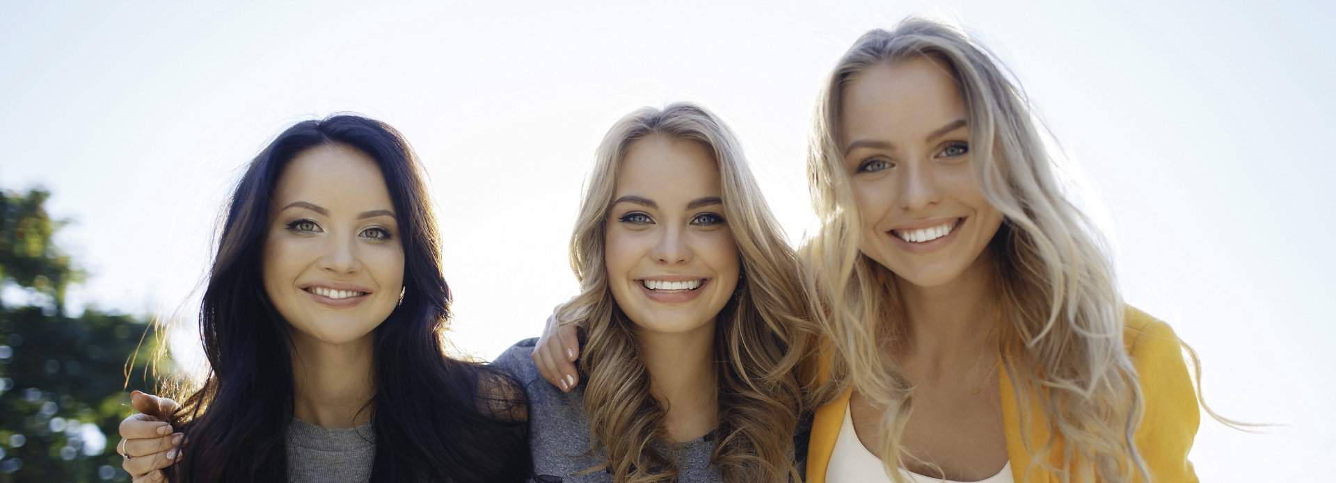three beautiful young women with perfect smiles