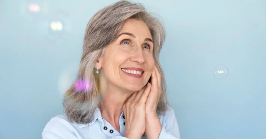 Smiling senior woman showing results of Affordable Dentures Atlanta