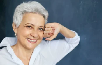 Confident woman smiling after Affordable Dentures and Implants
