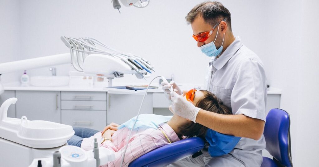 Dentist examining a patient's teeth during a routine dental checkup to maintain healthy teeth and gums.